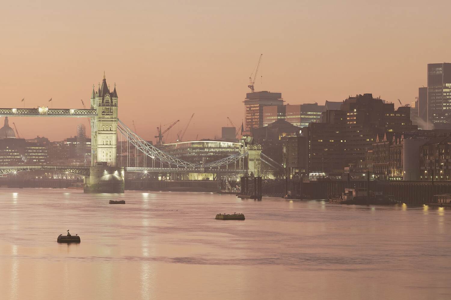Photograph of the Thames at sunset today, Tower Bridge lit and the City skyline behind it.